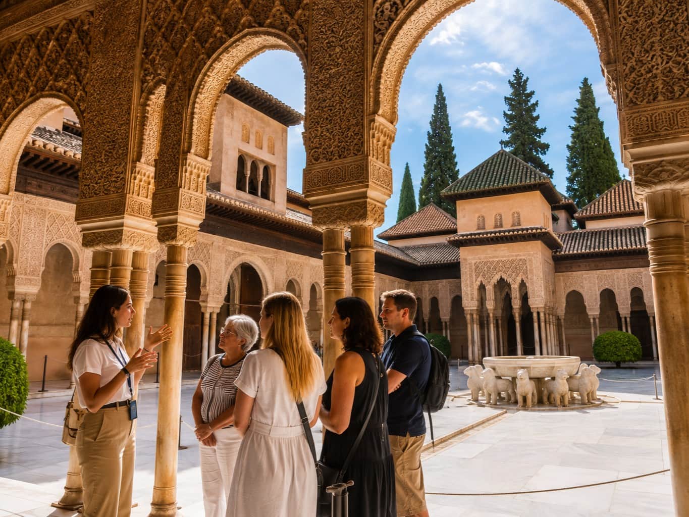 Small-group guided tour inside the Nasrid Palaces at the Alhambra in Granada, with ornate Moorish arches and the Court of the Lions.